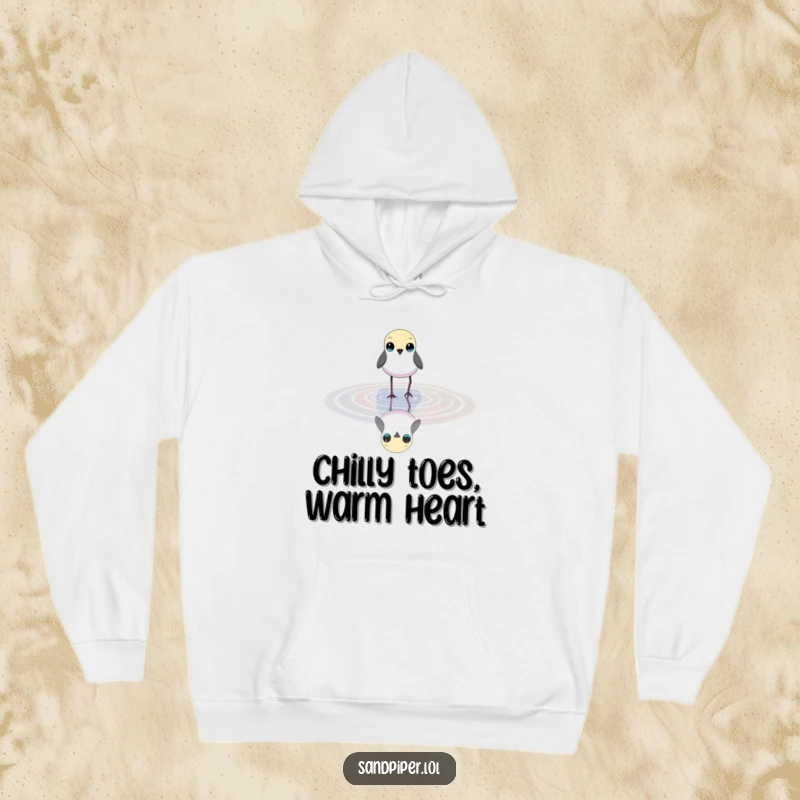 Funny hoodie depicting a small, slender bird with bright eyes wading in shallow water, offering cozy nature vibes.