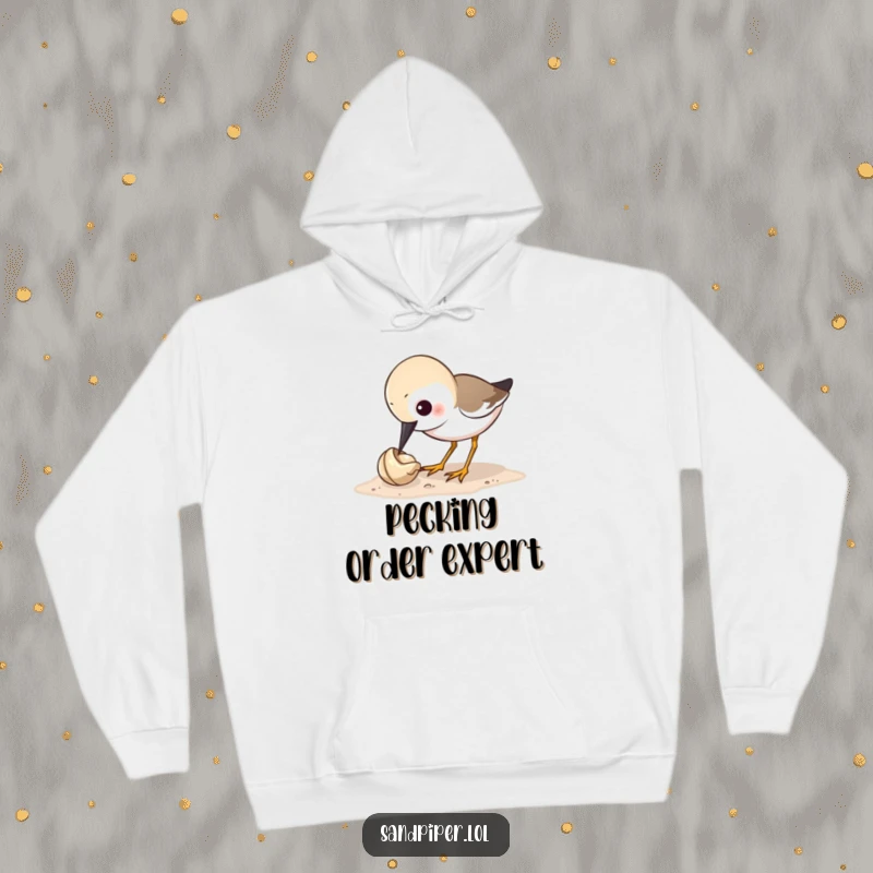Funny sandpiper hoodie depicting a bird humorously pecking at a tiny shell, ideal for bird watchers and those seeking funny gifts.
