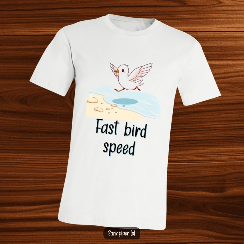 Funny t-shirt featuring a cute bird running energetically along a shoreline with wings outstretched, embodying coastal freedom.