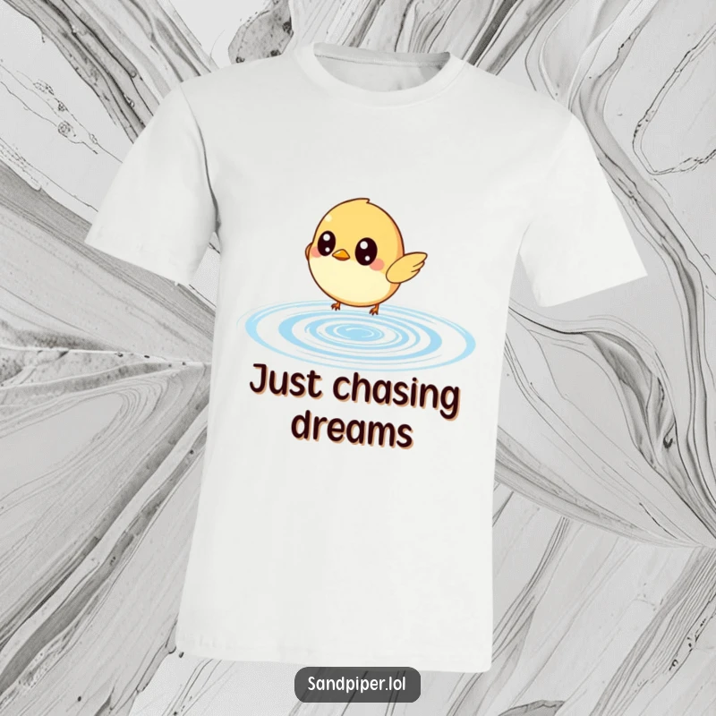 Funny t-shirt showcasing a small bird with incredibly wide eyes intently chasing a bouncing water ripple, embodying playful pursuit.