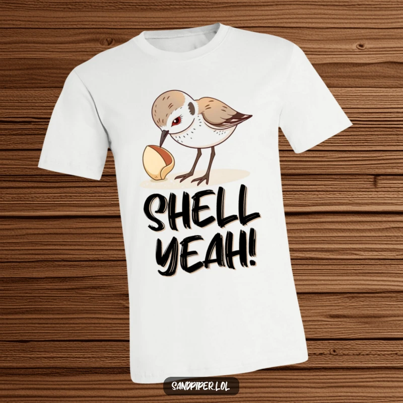 Funny t-shirt featuring a sandpiper chick looking down curiously at a seashell, a moment of beach exploration. A great funny gift.