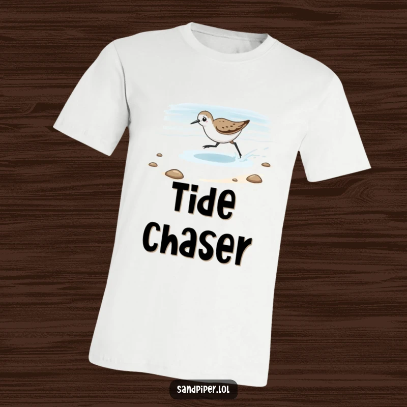 Funny T-Shirt depicting a sandpiper playfully chasing the receding tide, a humorous symbol of coastal pursuit.